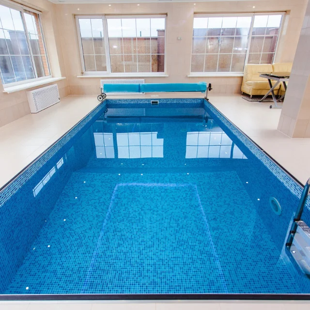 Residential backyard pool surrounded by a deck
