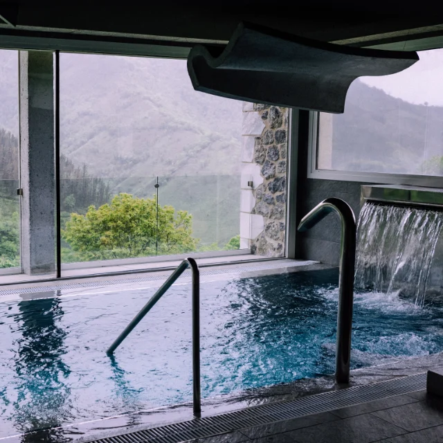 Pool with water features and a surrounding deck