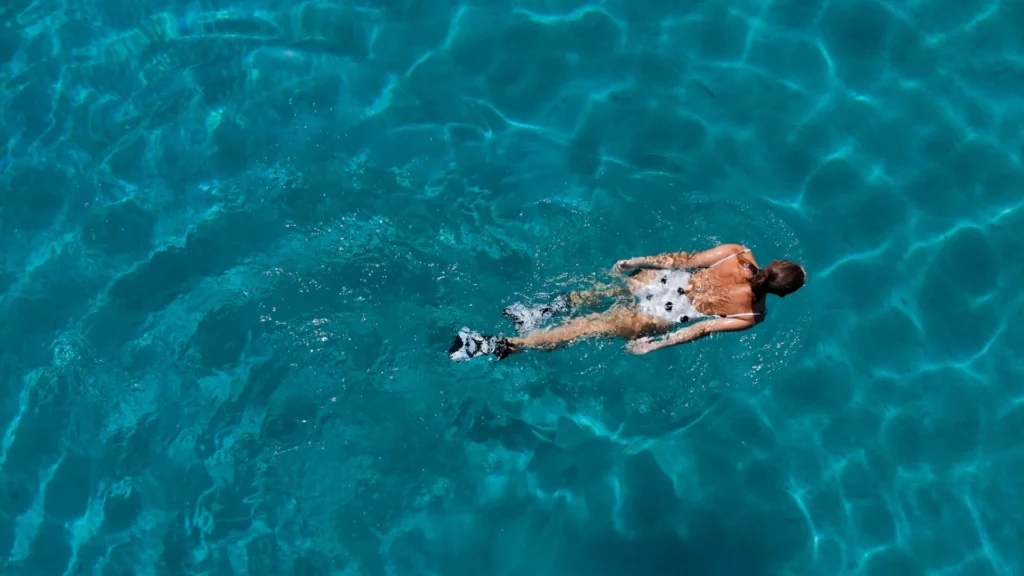 Swimming pool with a swimmer in clear water